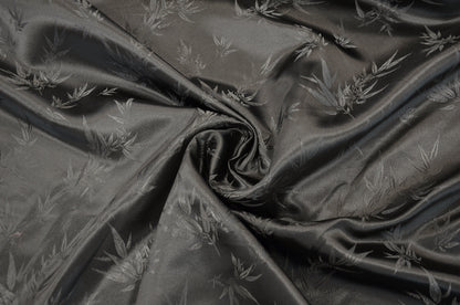 black fabric with subtle leaf pattern