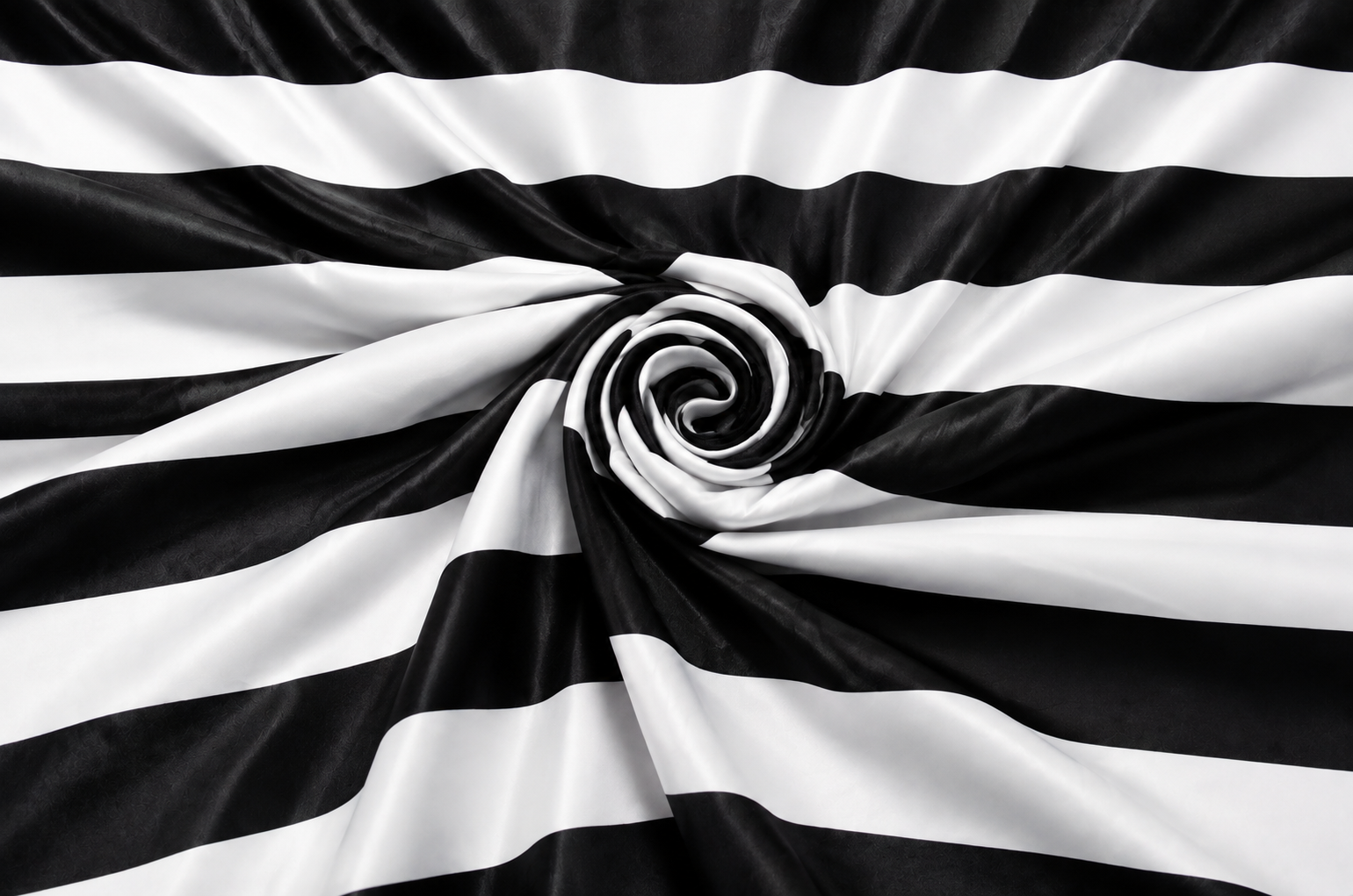 Black and white horizontally striped fabric draped in a spiral pattern, showing a smooth satin-like sheen.
