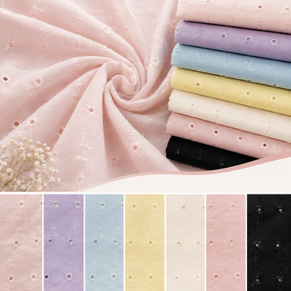 A fabric product display showing a light pink embroidered sheer fabric swirled in the air, with a stack of folded fabric samples in pink, lavender, light blue, pale yellow, cream, and black. A row of vertical color swatches at the bottom repeats the embroidered texture and shows the available color options.
