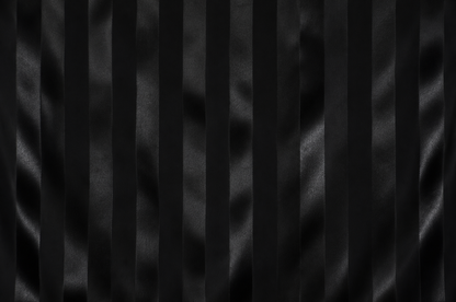 Black pleated fabric texture with vertical satin-like folds and a subtle sheen.