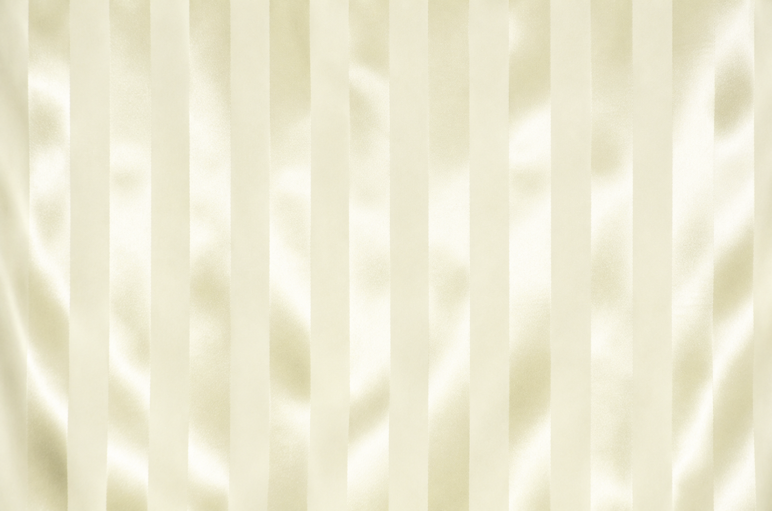 Close-up of a cream-colored fabric with a vertical satin-like stripe pattern and soft sheen.