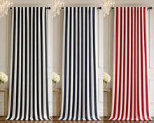 Three curtain panels with vertical stripes are displayed side by side in an interior room setting. The left panel is black and white, the middle panel is navy and white, and the right panel is red and white.