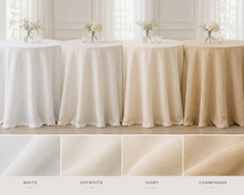 Four round tables draped in white, off-white, ivory, and champagne tablecloths, shown in a bright interior with floral centerpieces. Four fabric swatches at the bottom label the colors: White, Offwhite, Ivory, and Champagne.