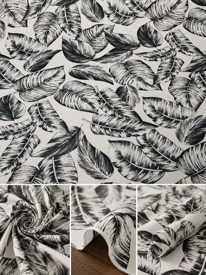 Black and white tropical leaf patterned fabric shown in a top flat view and three bottom detail panels, including a rolled section revealing the white backing and a draped section over a wood surface.